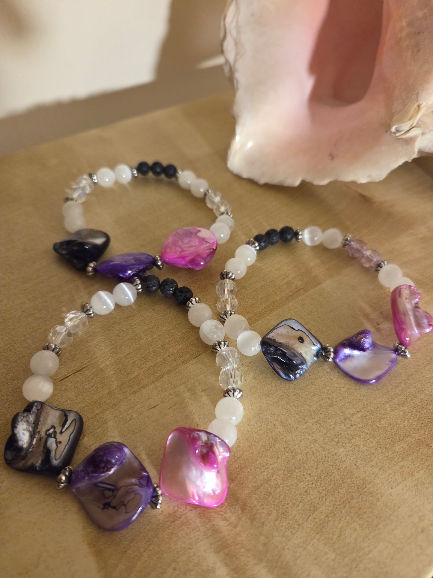 Mother of pearl, selenite and lava stone.