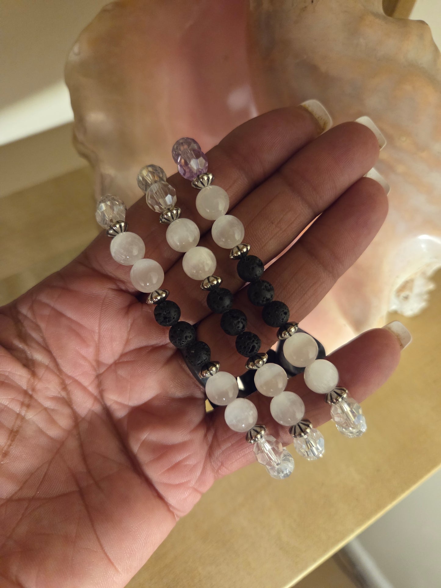 Mother of pearl, selenite and lava stone.