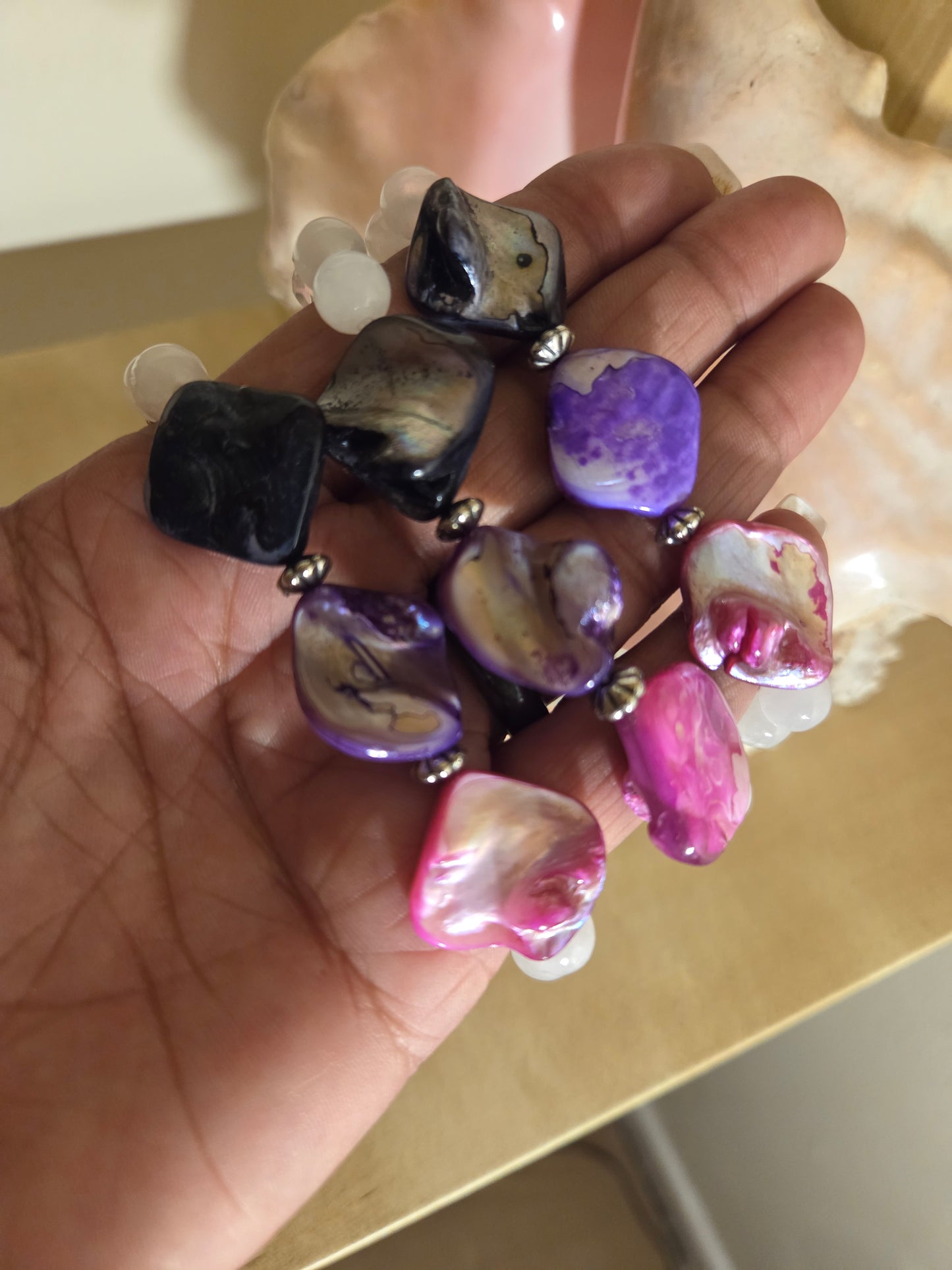 Mother of pearl, selenite and lava stone.