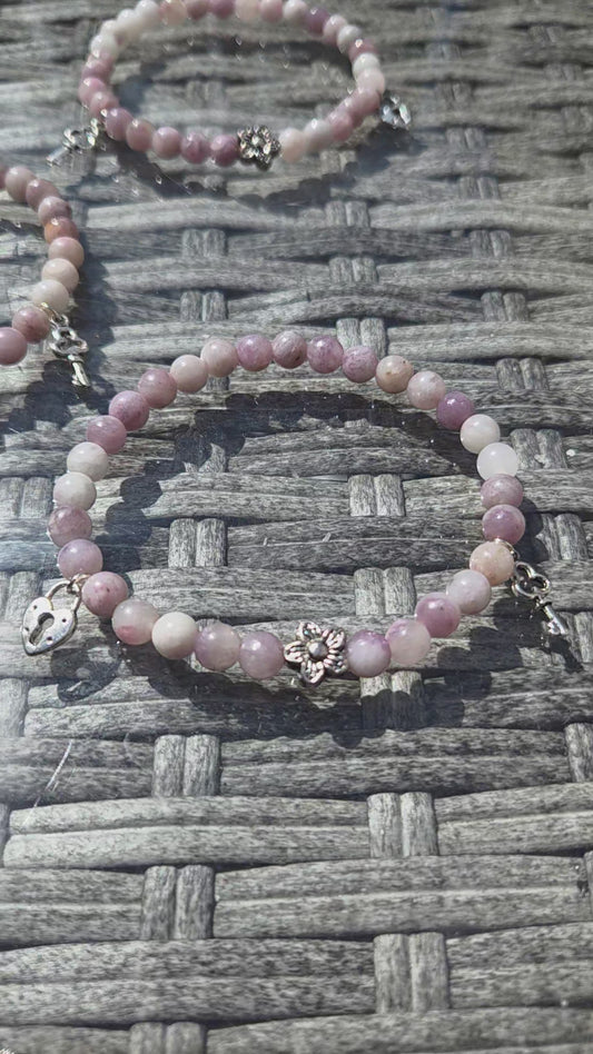 Pink tourmaline bracelet with lock and key charm.
