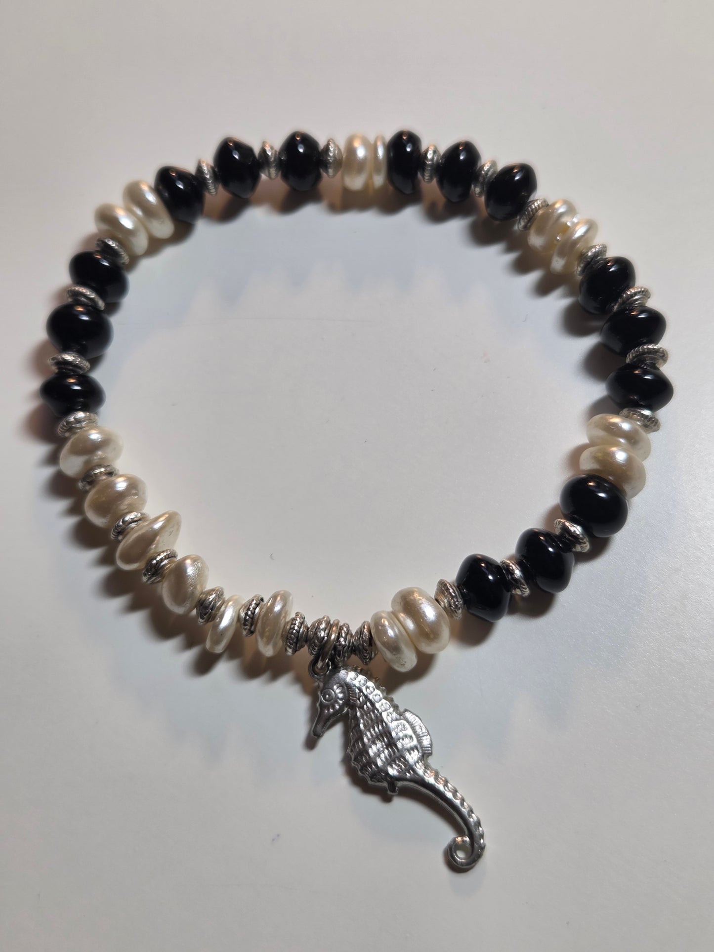 Obsidian, fresh water pearl and sea horse charm