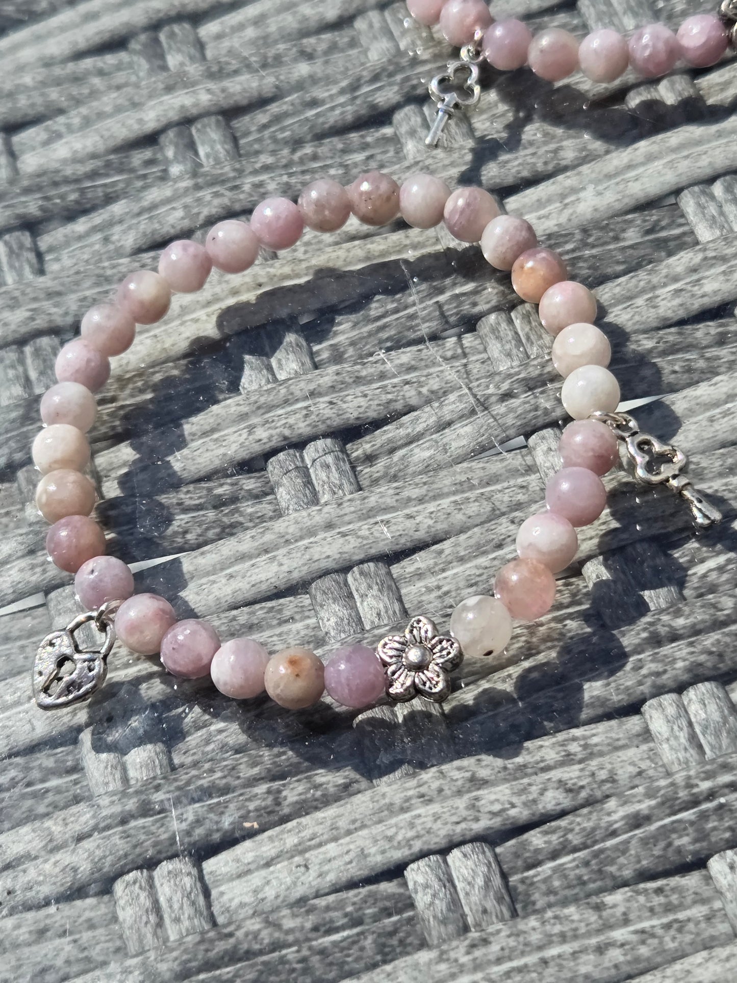 Pink tourmaline bracelet with lock and key charm.