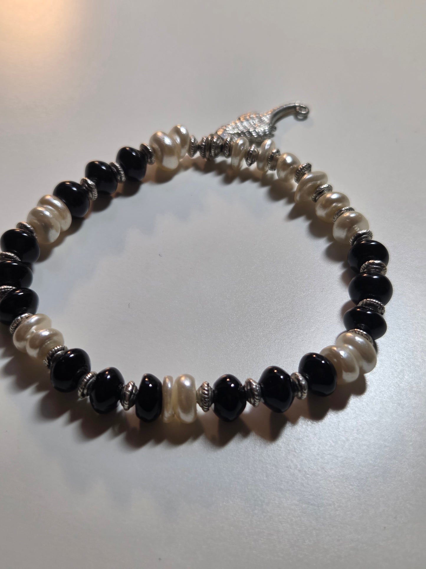 Obsidian, fresh water pearl and sea horse charm